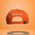 Orange baseball cap showing the embroidered phrase "Bring Cash" in white script.