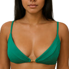 Green bikini top with palm tree charm on a white background