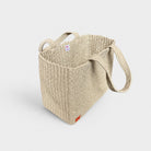 Natural woven tote bag, angled side view with open top.