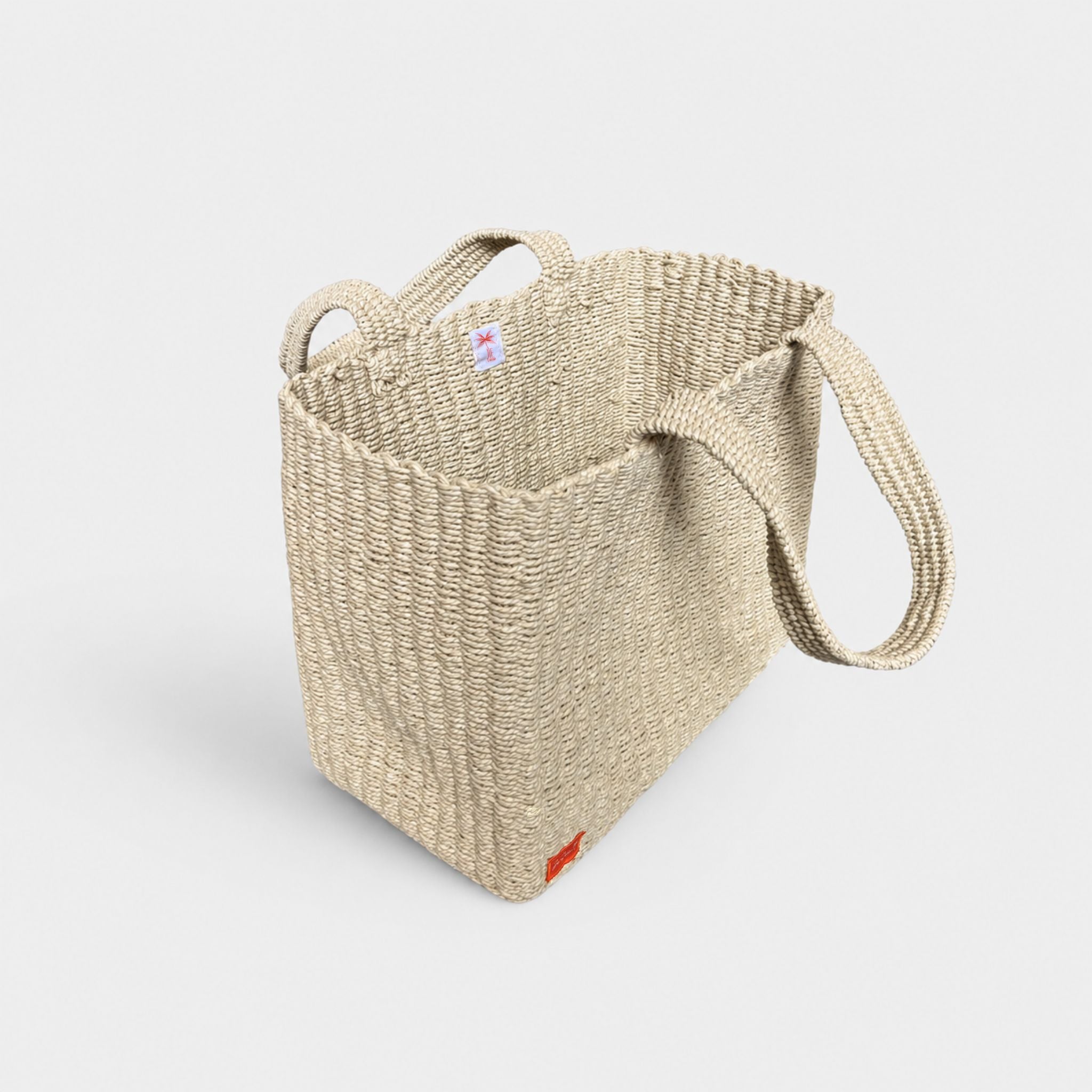 Natural woven tote bag, angled side view with open top.