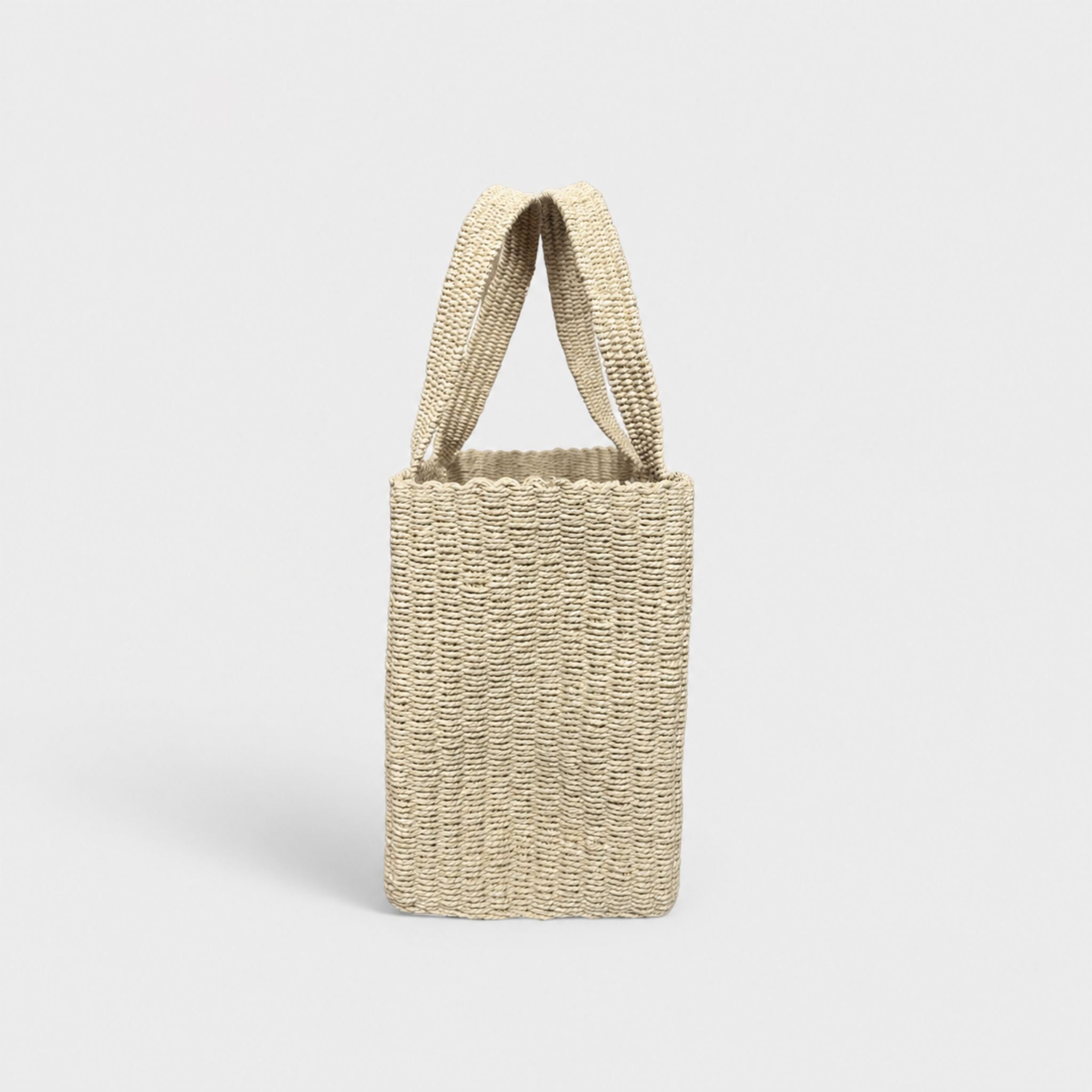 Natural woven tote bag, angled side view with open top.