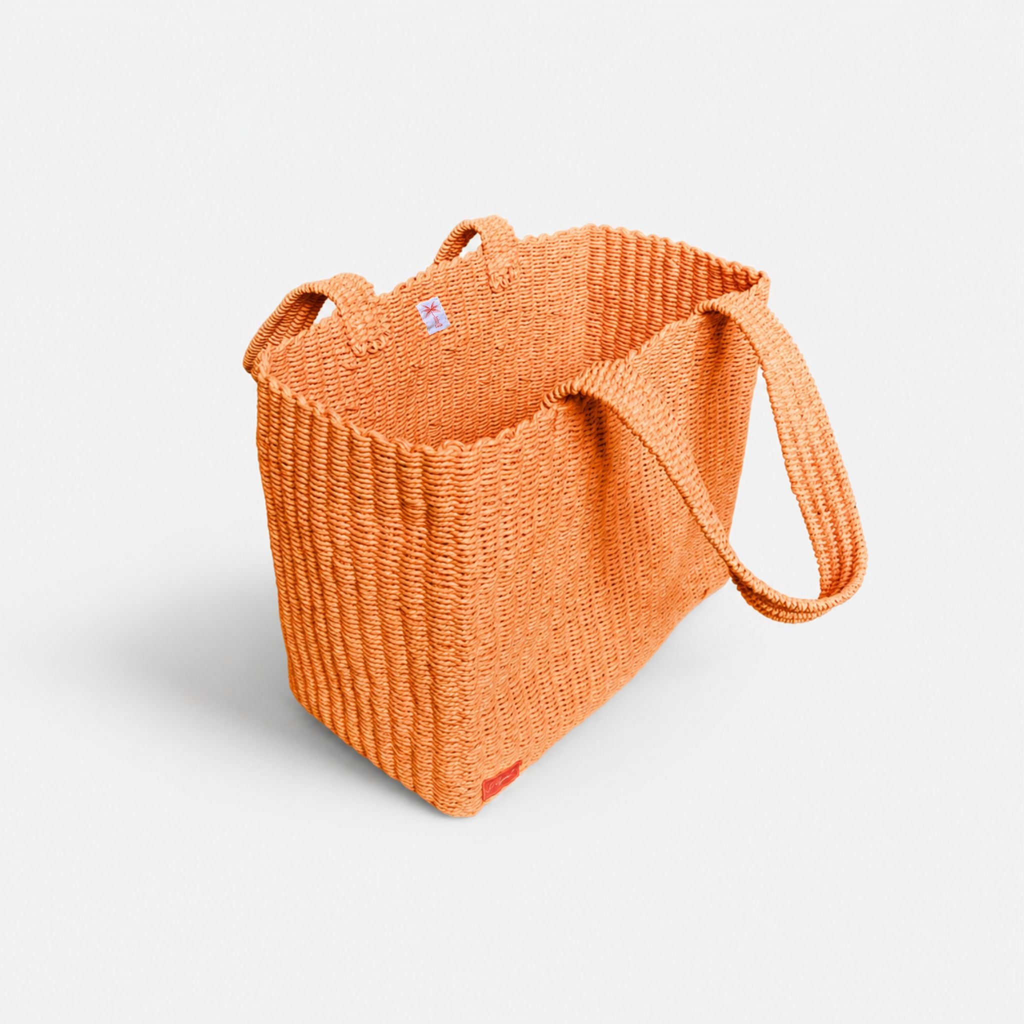 Orange woven tote bag, angled side view with open top.