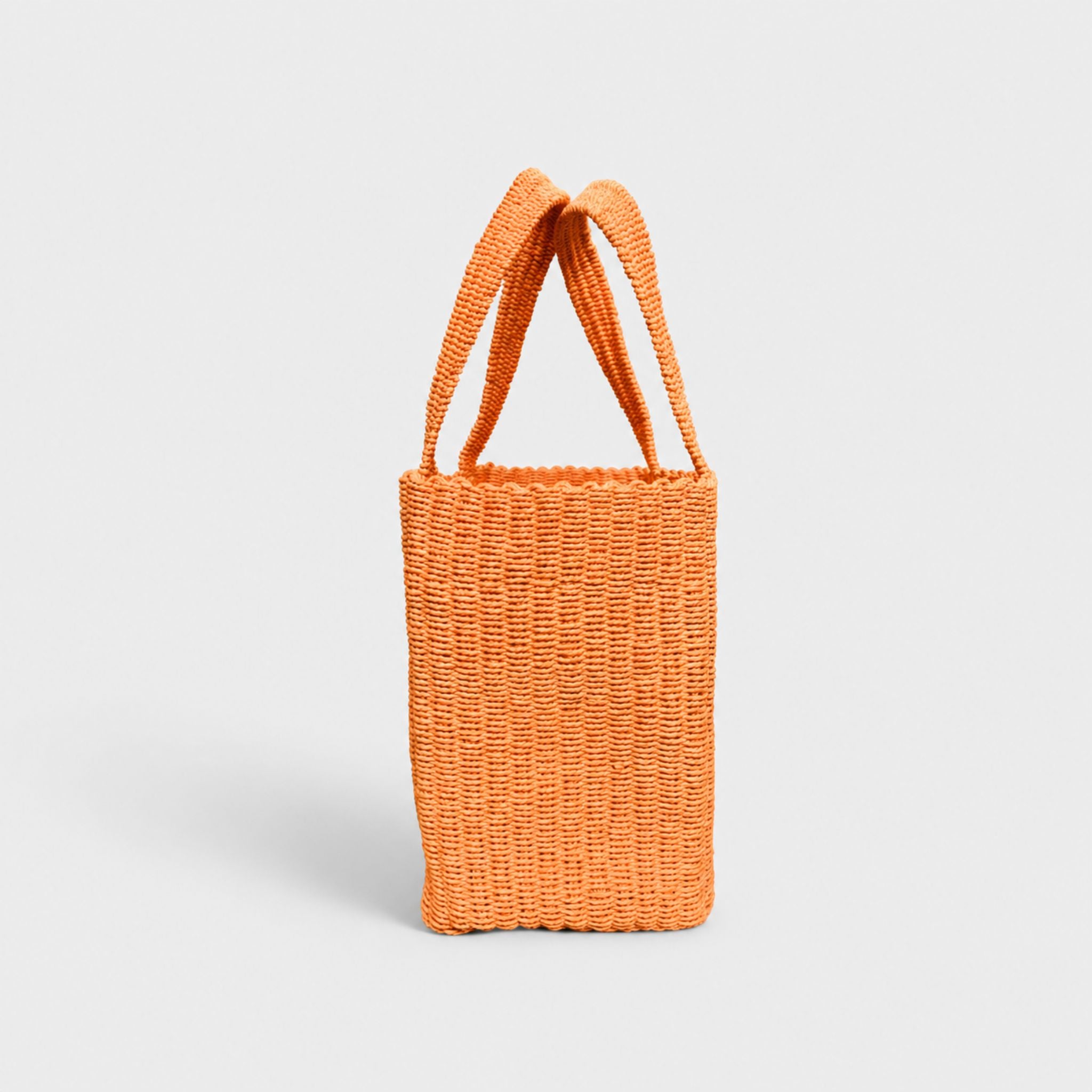 Orange woven tote bag, angled side view with open top.