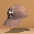 Brown JE Swim baseball hat with a white palm tree logo.