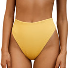 front of yellow bikini bottom on a white background