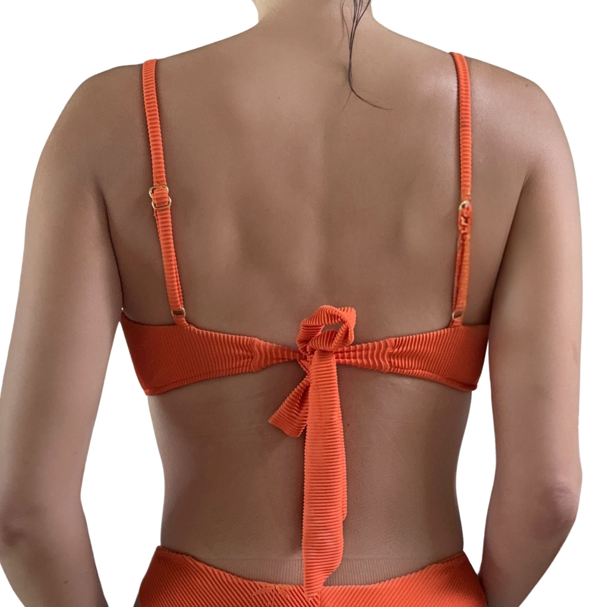 Orange bikini top with a tieback and adjustable straps on a white background