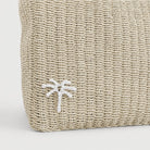 Natural woven tote bag, front view with palm tree raffia detail